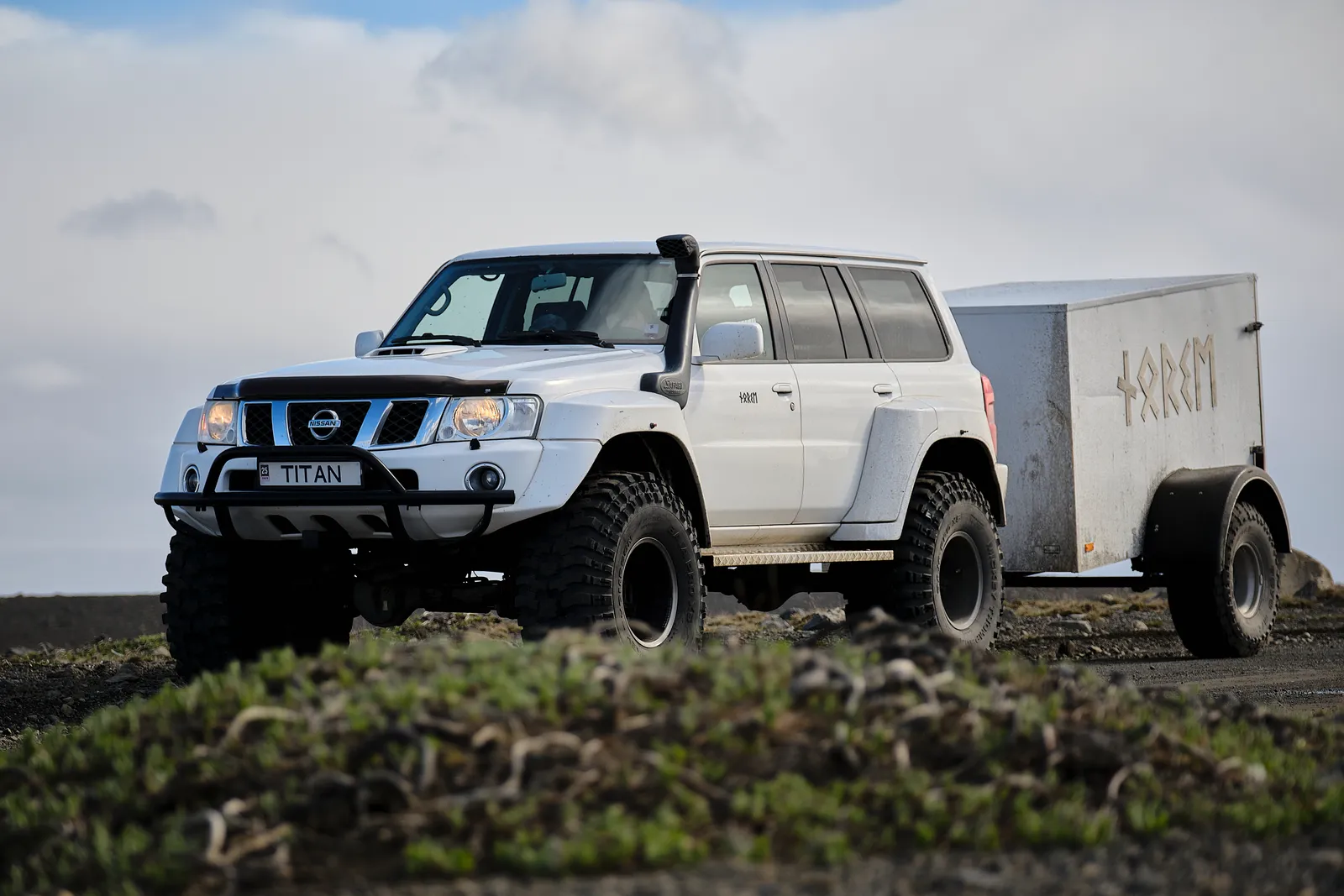 Norse Adventures modified Nissan Patrol and luggage trailer on a Highland track