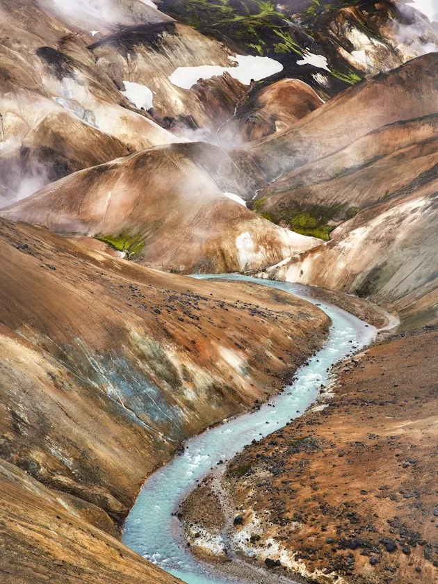 Steam and rhyolite hills in Hveradalir hot spring valley on Ancient Trails