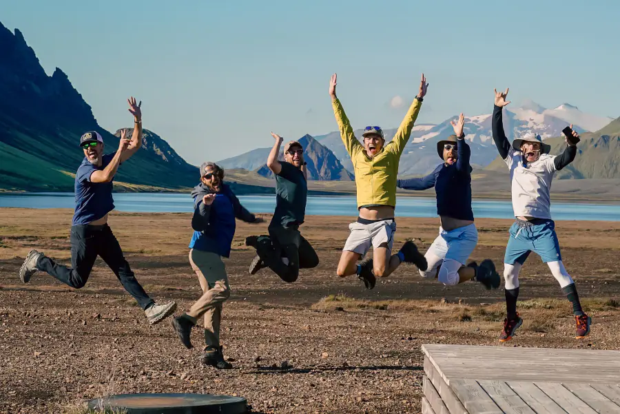 Happy group of hikers outside Alftavatn Hut in Iceland with Norse Adventures