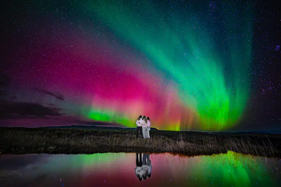 Northern lights over a dark Icelandic winter landscape