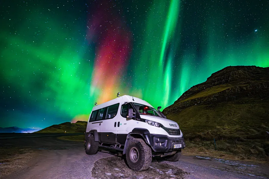 Norse Adventures IVECO Supertruck parked beneath the northern lights