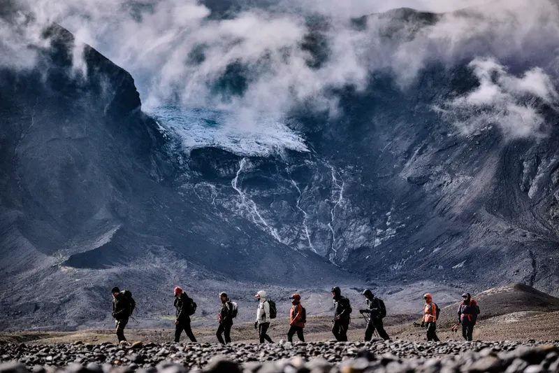 Ancient Trails hikers walking beneath Hrútfell and its glacier