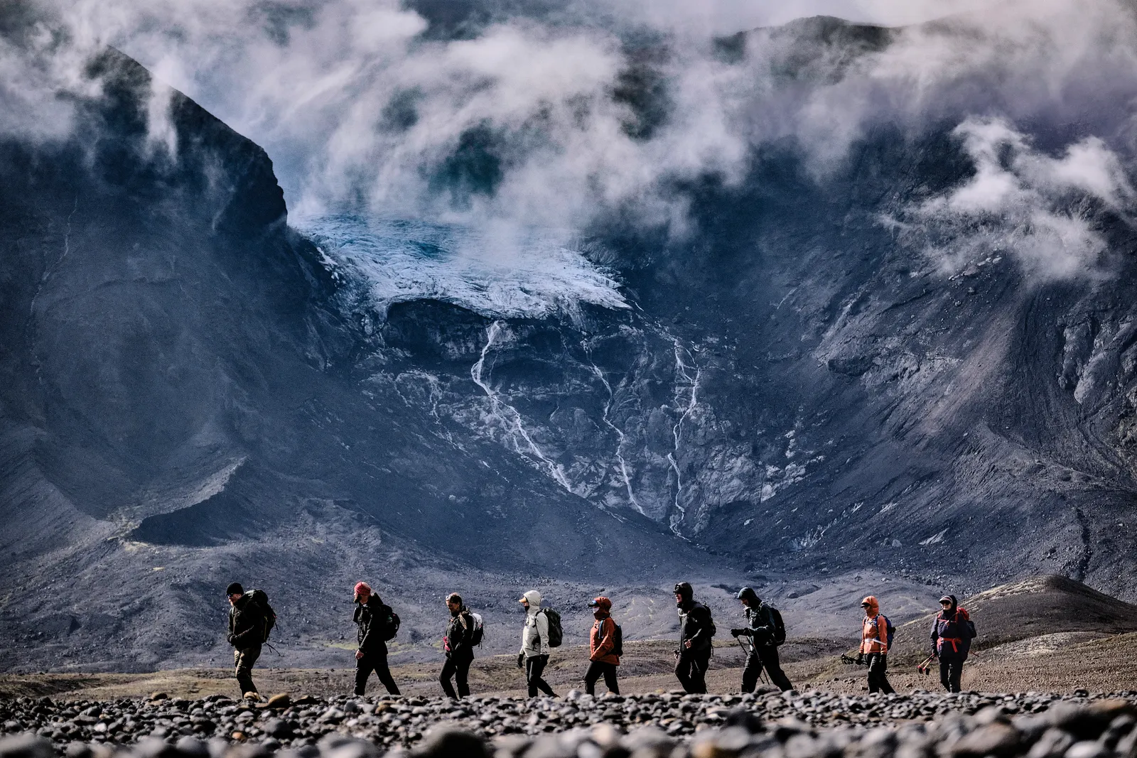 Ancient Trails hikers walking beneath Hrútfell and its glacier